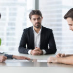 Spouses couple signing decree papers getting divorced in lawyers office